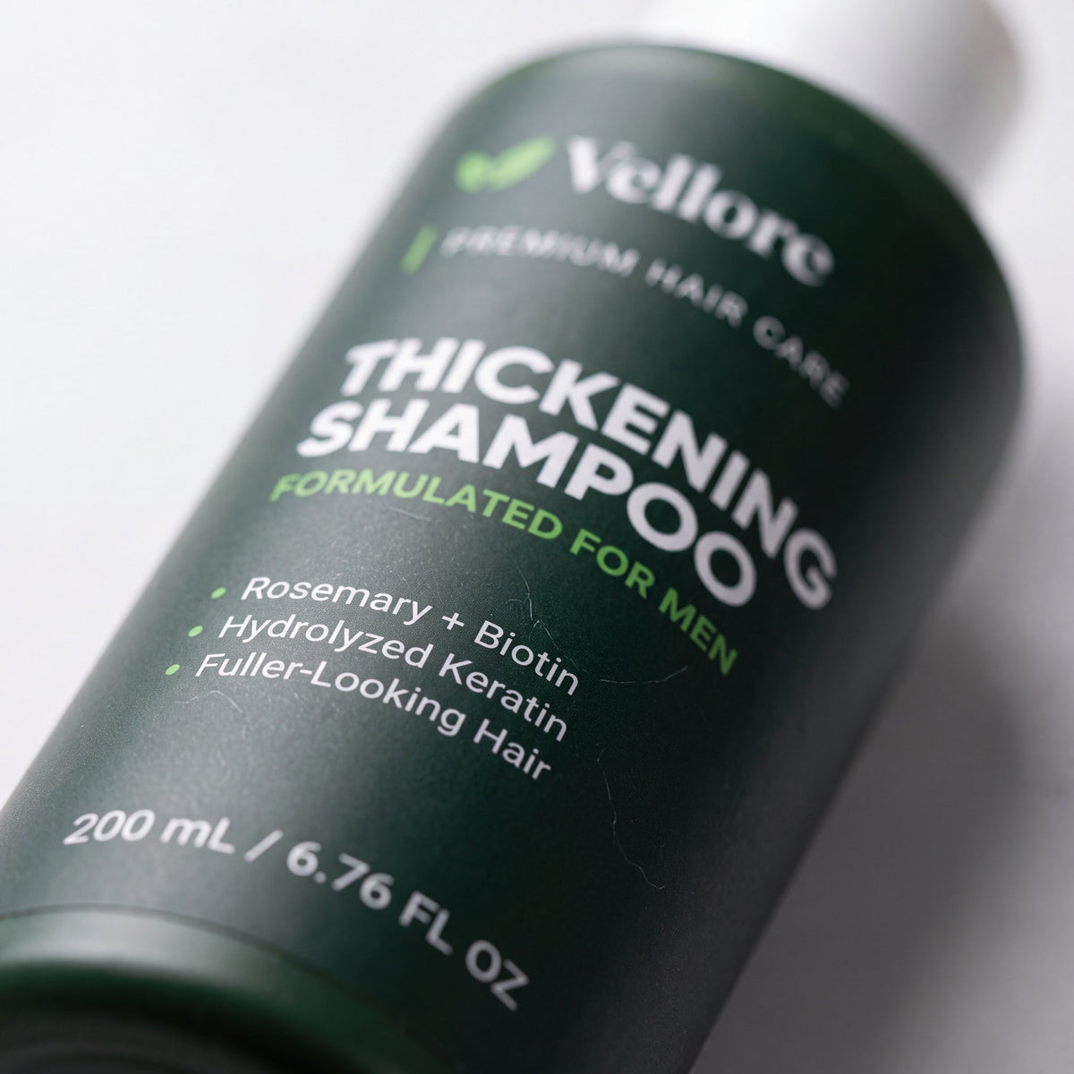 Close-up of the Thickening Shampoo for Men label with rosemary, biotin and keratin